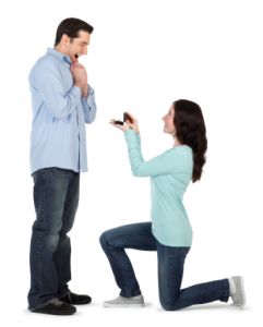 woman on her knee proposing marriage to man