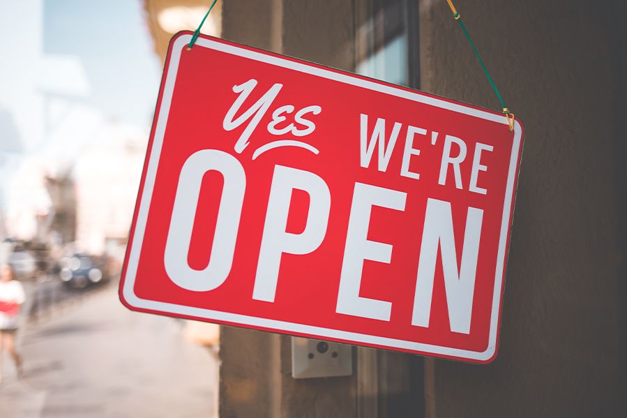 sign on door reading yes we're open