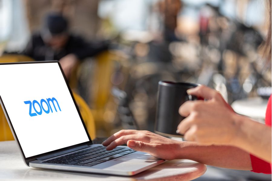 A woman logging into a Zoom meeting on a laptop