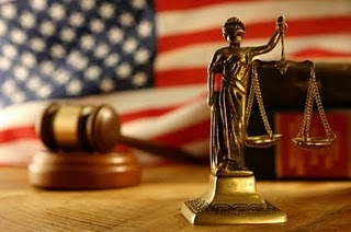 scales of justice in front of American flag