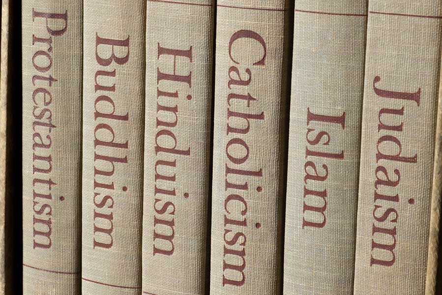 a group of religious books on a shelf