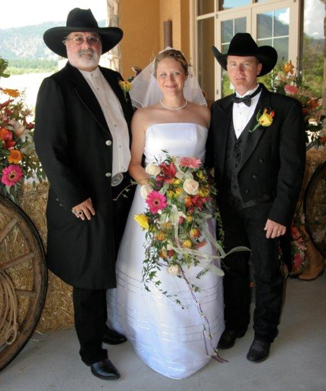 This cowboy themed wedding finishes with a photo of the Bride, Groom and the Minister.