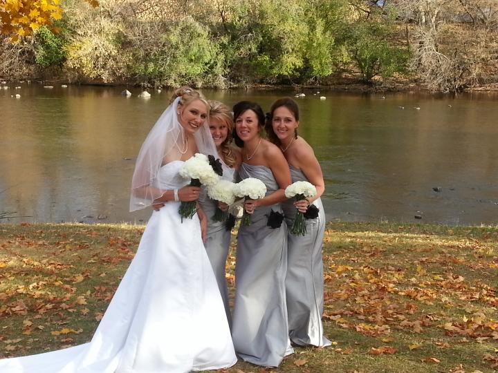 Bride posing with her bride’s maids after the ceremony has ended.