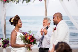 African-American couple getting married by a Universal Life Church ordained minister at beach wedding