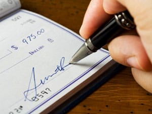 Ministerial Discounts Signing a Check