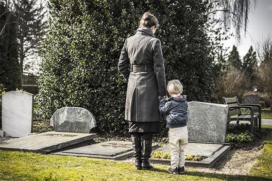 Mom and son attending a gravesite