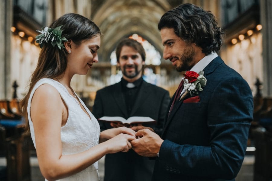 Bride and groom smiling during wedding ceremony at Christian church