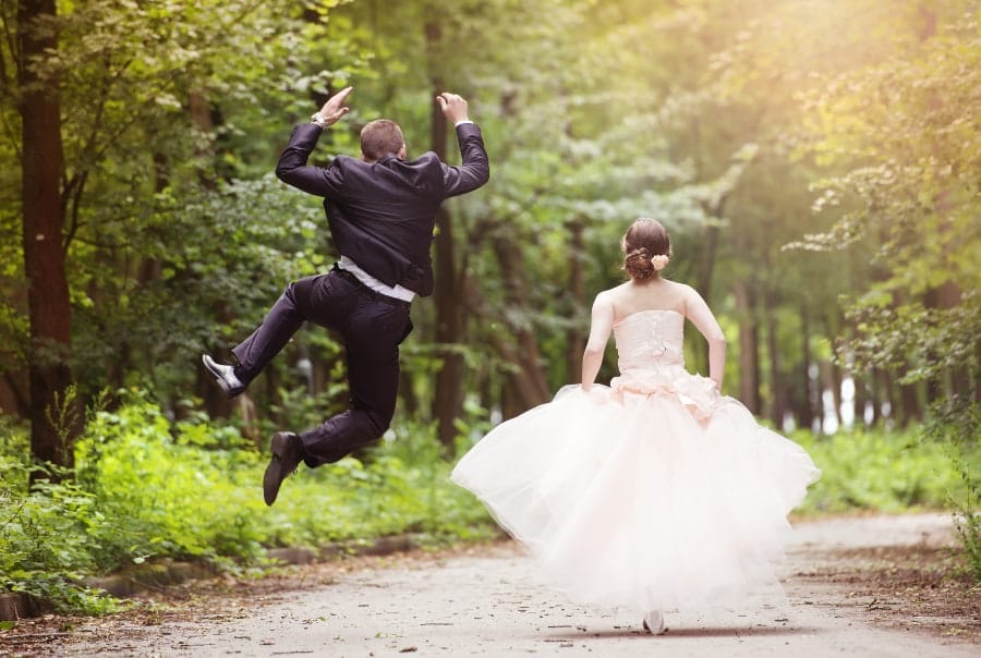 Funny newlywed husband kicking heels after getting married