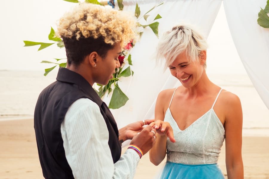 Newlywed brides embracing after humanist wedding ceremony