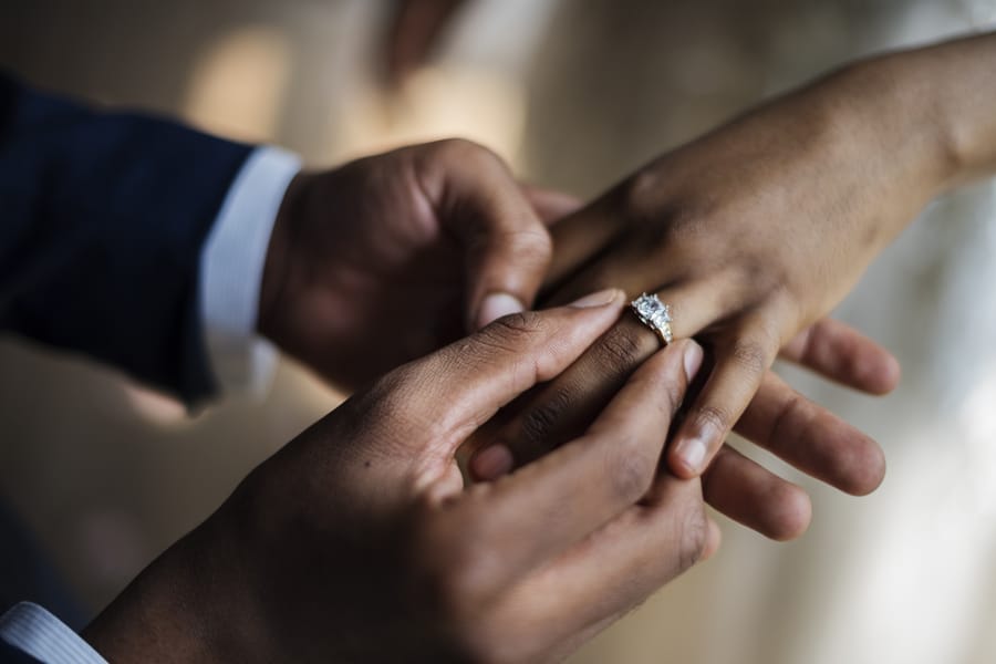 Happy bride and groom during wedding ceremony ring exchange