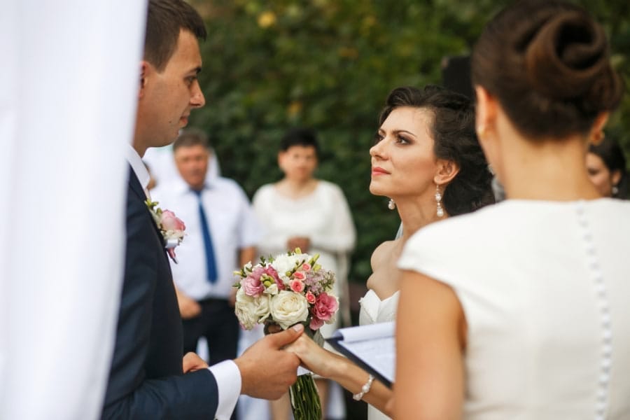 Bride and groom looking passionately together during romantic wedding