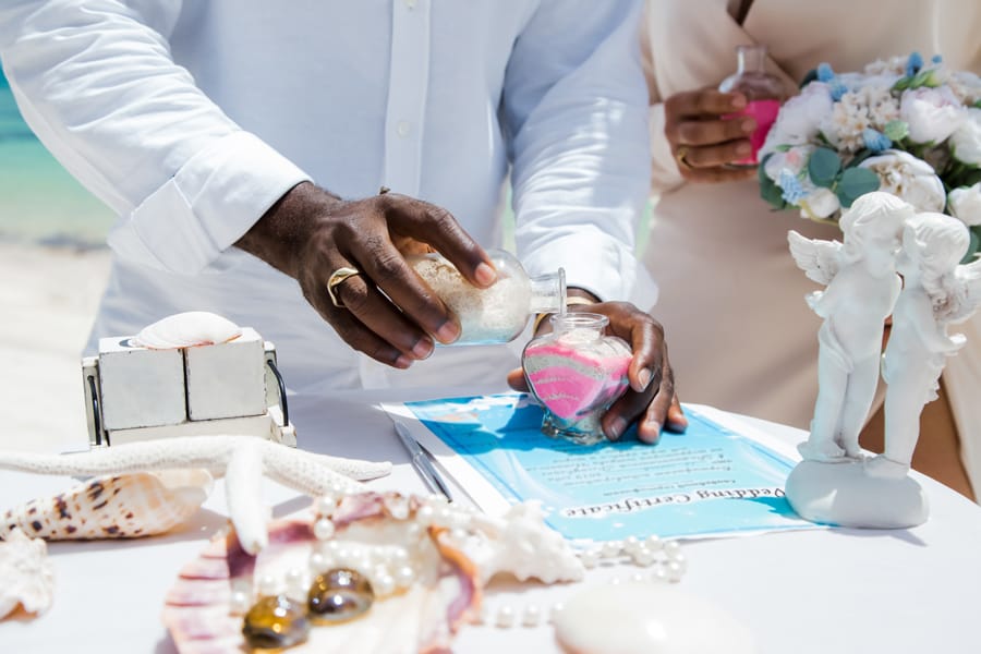 Bride and groom pouring salt to symbolize unity at wedding