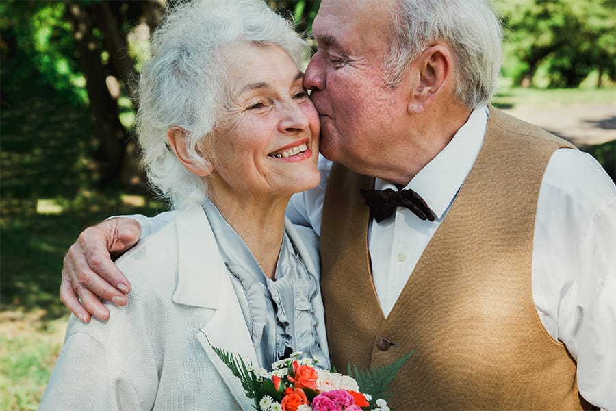 Elderly couple kissing after renewing vows