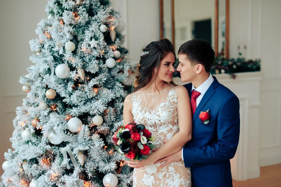 Newlywed couple kissing in the snow after winter solstice wedding