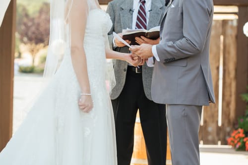 Couple getting married by a close friend