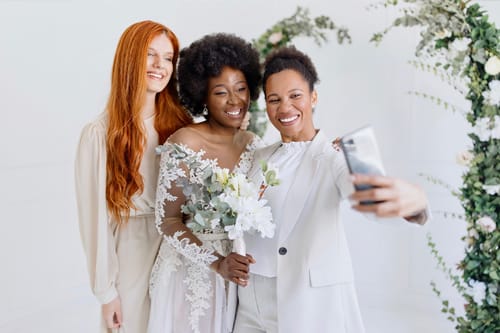 Wedding Officiant Taking Selfie With Couple