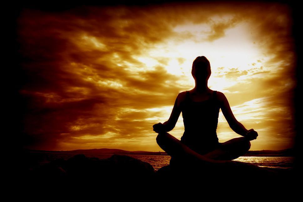Woman Meditating Meditation silhouette of woman against orange sky