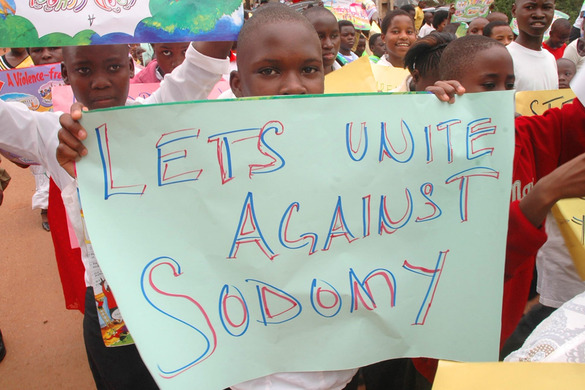 African children holding anti-gay signs.