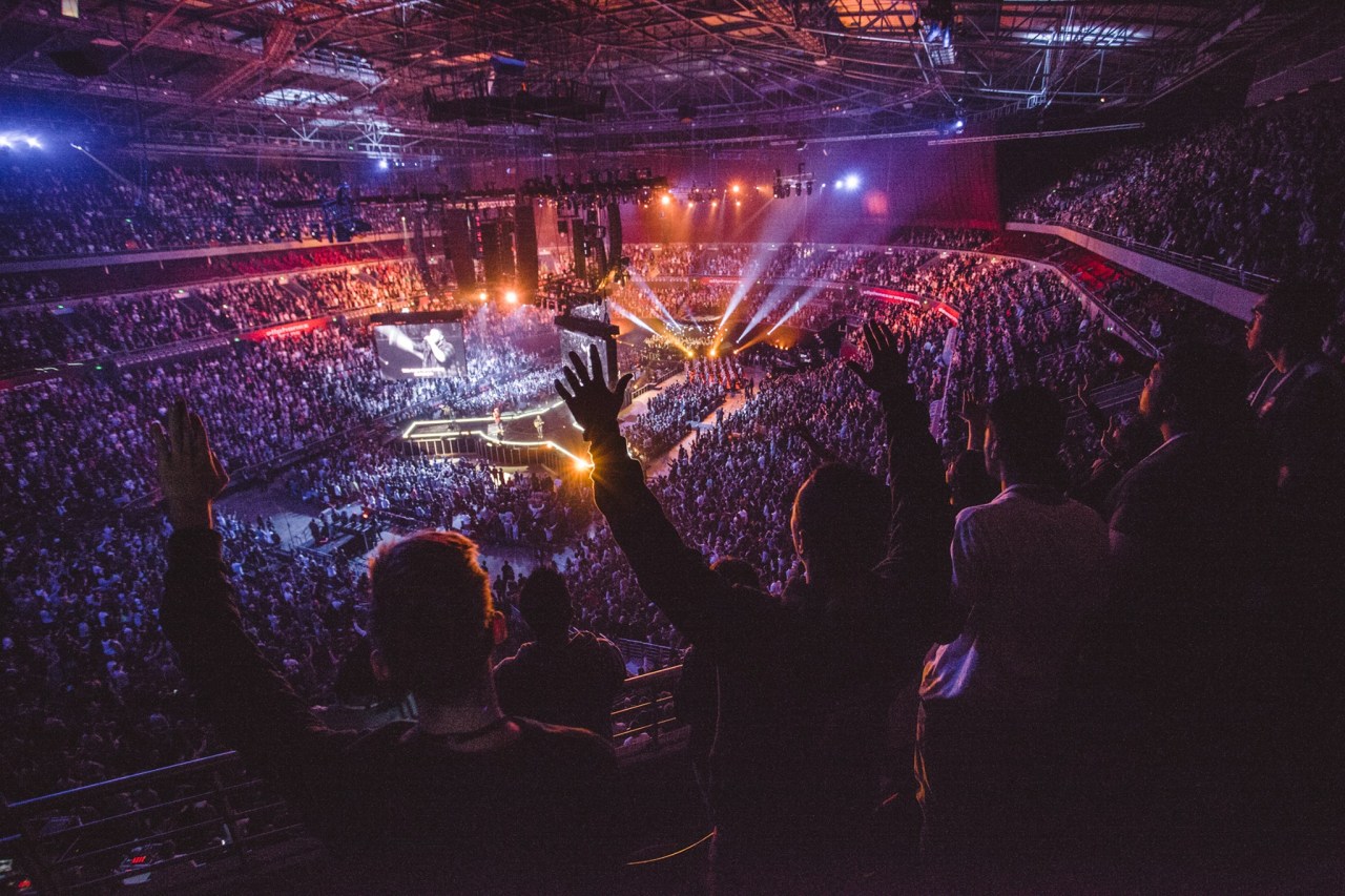 A pastor addresses congregation at megachurch.