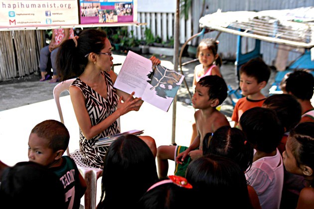 An atheist in the Philippines reading to young children