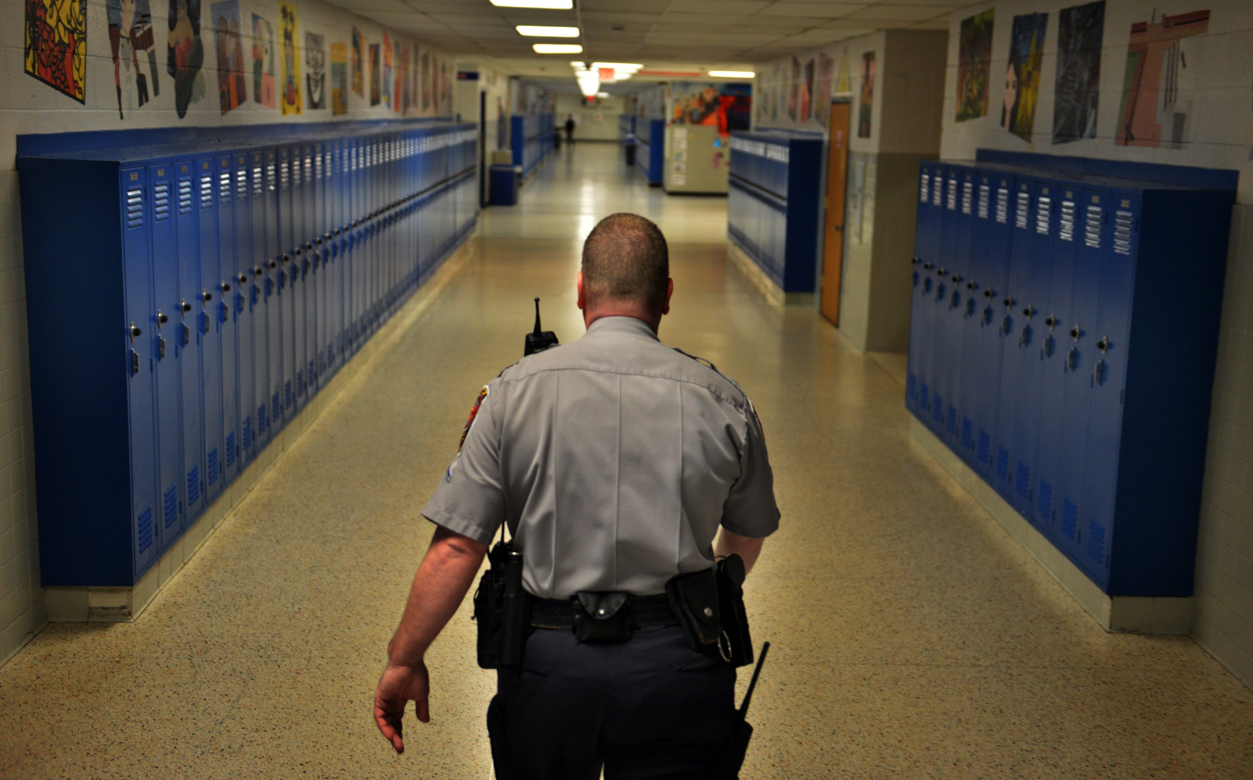 A school police officer walks the halls.