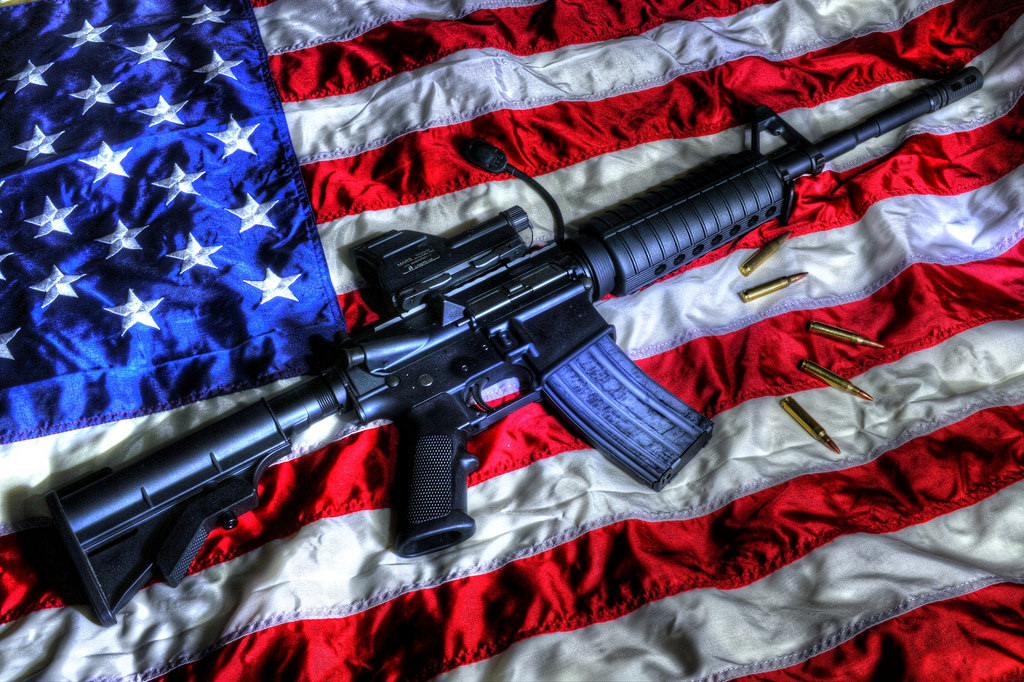 A gun sitting on an American flag.
