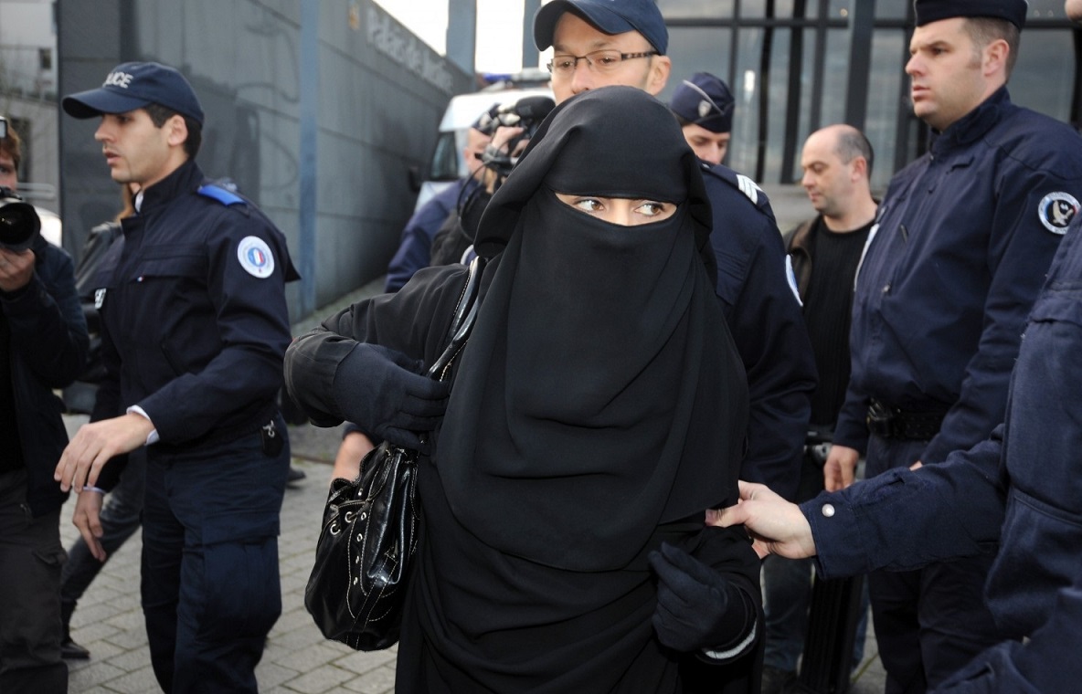 A woman being arrested in France for wearing a niqab